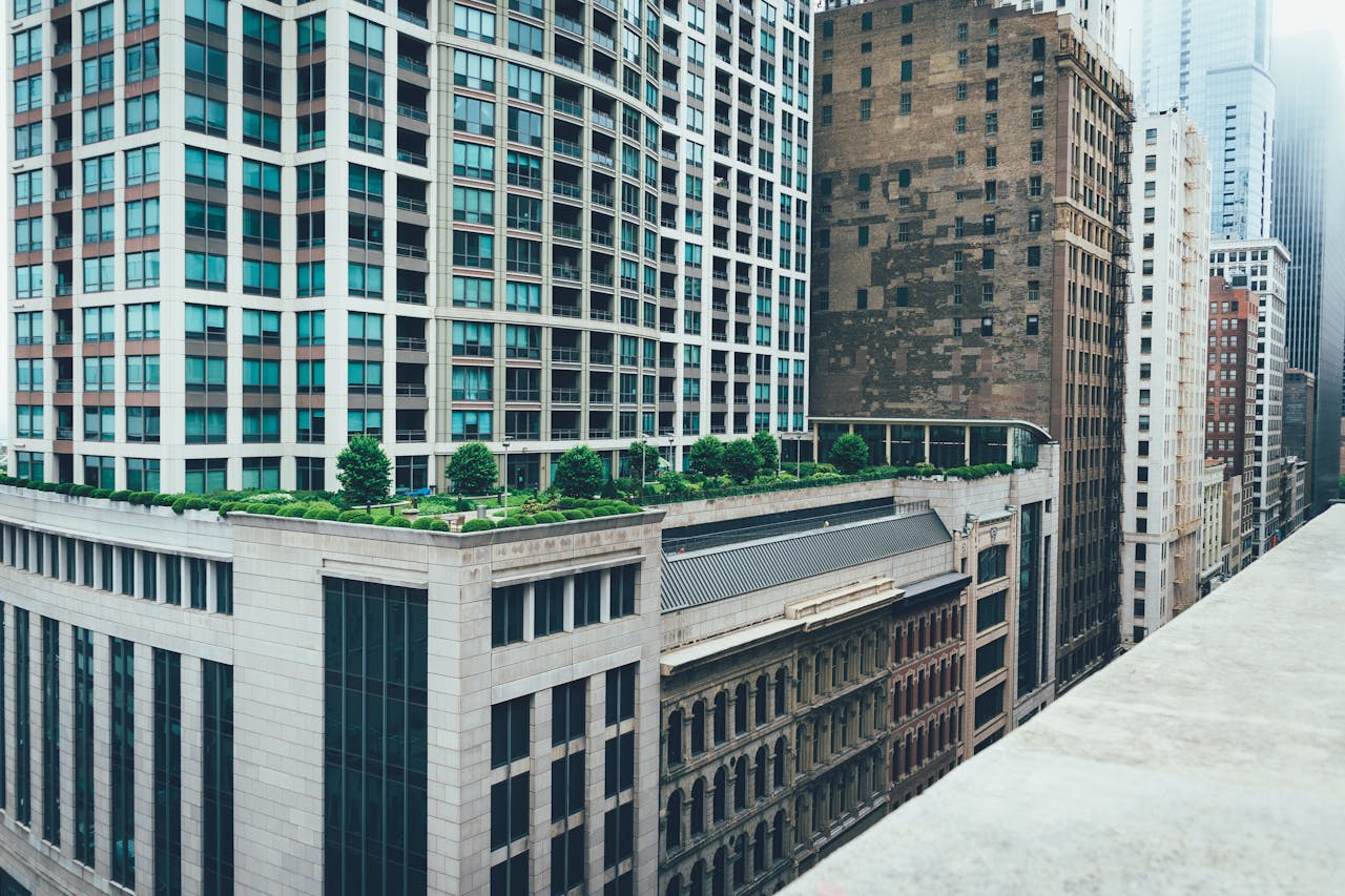 A cityscape with high-rise buildings and a green rooftop garden.